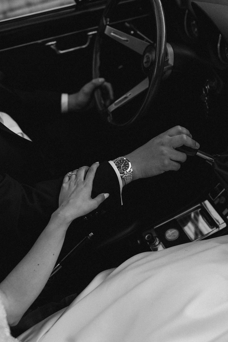 Brides hand on Grooms hand holding Rolex watch Alfa Romero